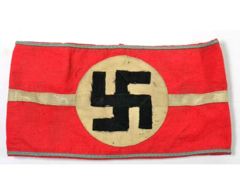 A German Third Reich NSDAP Armband to a Kreisleiter, in red cotton with applied white circular panel further applied with bla