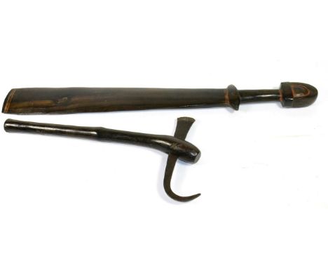 A Massim, Trobriand Islands Dark Hardwood Sword Club, with 51cm spatula type head, cylindrical grip and arched pommel, 71cm; 