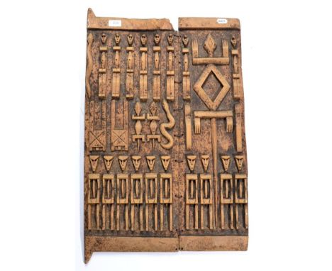 A Dogon Two Panel Granary Door, Mali, relief carved with rows of figures, lizards and snakes, with peg hinges, 75cm by 45cm 