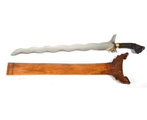 A Mid/Late 20th Century Moro Kris, with twelve lok polished steel blade, the lacquered wood hulu tapa gudu type hilt with wov