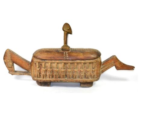 A Dogon Large Ceremonial Wood Trough (Ark of the World),  Mali, of rounded rectangular form on shaped block feet, relief-carv