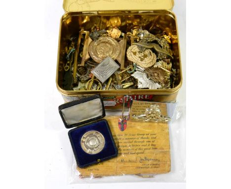 A Quantity of British Militaria, including cap and collar badges, rank pips, buckles, a Soldier's Service and Pay Book, a cas