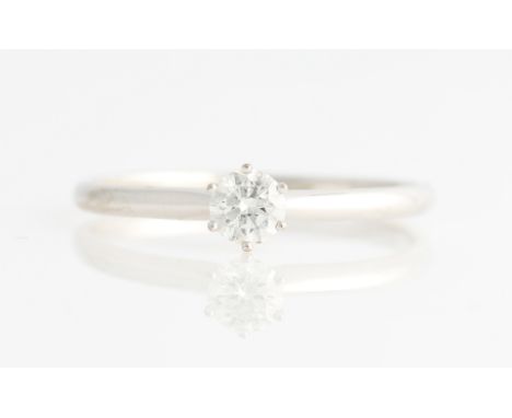 A diamond solitaire ring, set with a round brilliant cut diamond, measuring approx. 0.50ct, stamped 18K, ring set Z+3, with a