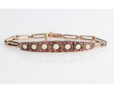 An opal and ruby bracelet, each of the seven square articulated links set with graduated round opal cabochons and round cut r
