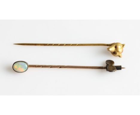 A novelty fox head stick pin, together with an opal cabochon stick pin, (2).