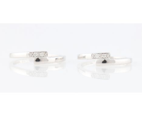*Two diamond set cross over design rings, each set with two round brilliant cut diamond accents, white metal both stamped 375