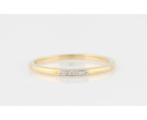 *A diamond ring, set with six round brilliant cut diamond accents, yellow metal stamped 375/1000, ring size L.