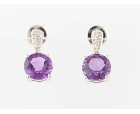 *A pair of amethyst and diamond drop stud earrings, each set with a round cut amethyst, suspended from diamond set metalwork,
