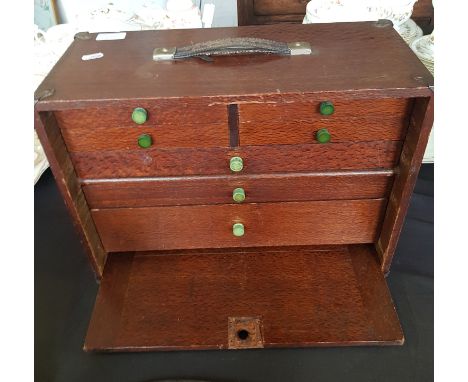 An oak portable engineers tool box with tools.