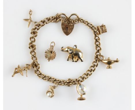 A curb link bracelet, suspending six various charms, to include a pair of scissors, a globe, a ballerina etc., bracelet stamp