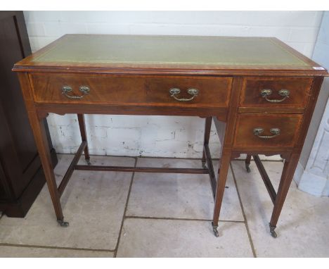 An Edwardian writing desk with one large drawer and a bank of two small drawers, a leather top, satinwood veneer inlays, term