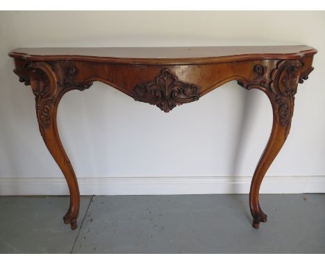 A 19th Century walnut ornately carved console table on cabriolle legs, 148cm W x 45cm D x 93cm H - in good condition 