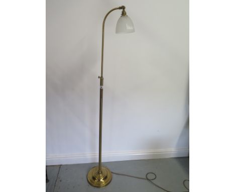 A brass extending standard reading lamp 