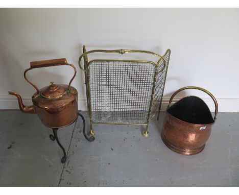 A brass fire screen, copper scuttle and copper kettle on stand 