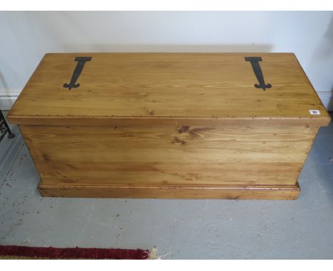 A contemporary pine trunk, approximately 107cm wide, 43cm deep, 45cm high, in good condition and made by a local craftsman to