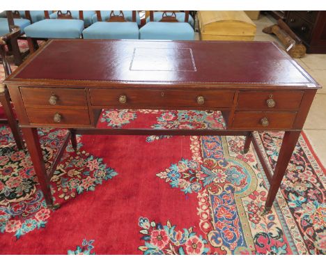A Georgian kneehole writing desk, with four  drawers including a faux double fronted drawer, tapered legs terminating in bras