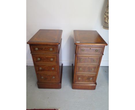 A pair of mahogany lamp tables with walnut veneers bordered with herring bone veneers, each with four drawers, approximately 