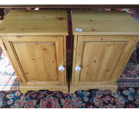 A pair of modern pine bedside cabinets with ceramic handles, approximately  59cm high, 38cm wide 29cm deep 