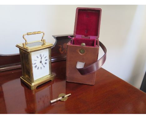 A 19th Century carriage clock, in working order with its key and case, 14cm High 