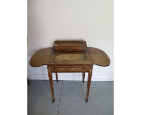 A 19th Century rosewood ladies writing desk inlaid with swags and angels, with two drop flap sides and an adjustable leather 