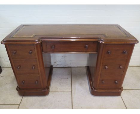 A Victorian mahogany kneehole desk with leather insert top, approximately 130cm wide, 77cm high, 51.5cm deep, in a restored a