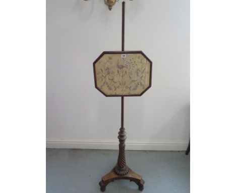 A Georgian mahogany fire screen on a reeded stem 