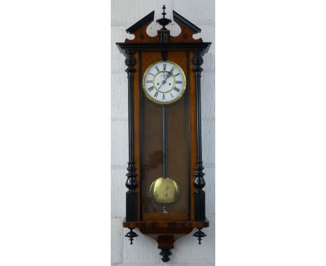 A double weight Vienna style wall clock, having eight day movement striking on a single gong, the brass and white enamel dial