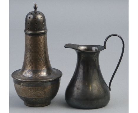 A cream jug, of tapering form with scroll loop handle, 11cm high, Birmingham 1915, 3.11ozs, together with a bakelite lined ca
