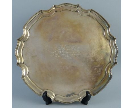 A presentation salver, of circular form with Chippendale moulded rim inscribed "Presented to Louis Hebblethwaite Esq. by past