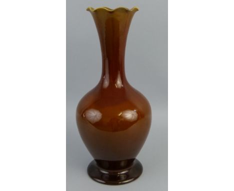 A Linthorpe pottery vase, of bottle shaped form with undulating rim and all over treacle glaze, impressed mark and no.2224, 4