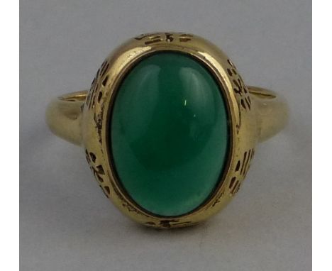 A Chinese jade ring, comprising an oval panel in setting pierced with Chinese Mons on 18ct gold shank, stamped 750, size S