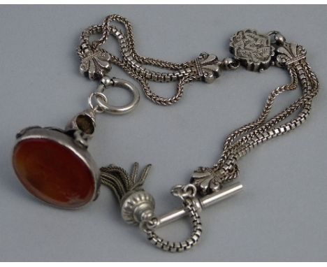 A continental white metal Albertina, with T-bar, tassel and chased panels suspended with a white metal fob seal, the cornelia