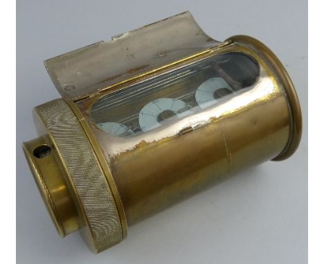 An early 20th Century brass cased pigeon racing clock, of barrel shaped form, the hinged lid to the top opening to reveal a g