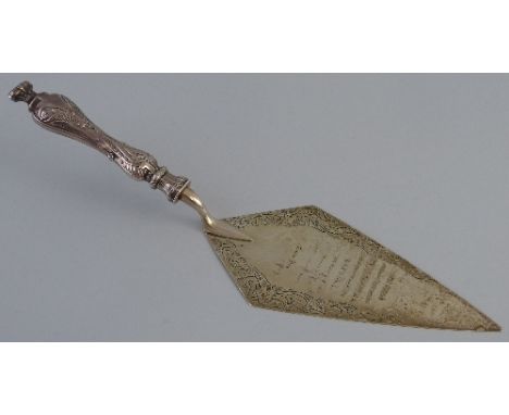 A Victorian presentation trowel, having leaf embossed haft and scrolling foliage chased blade with latin inscription "Hac Tru
