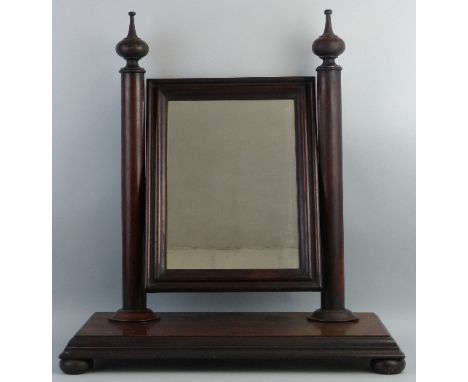 A Victorian mahogany swing toilet mirror, the oblong plate with moulded frame on plain column supports with turned finials an