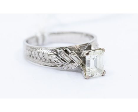 A diamond and white metal solitaire ring, the claw set emerald cut diamond weighing approx. 0.90ct assessed colour K/L , asse