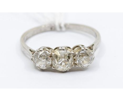 A diamond three stone platinum ring, comprising three graduated claw set  old cut diamonds, total diamond weight approx. 1 ca