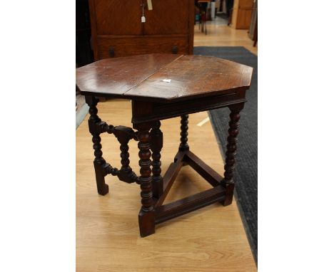 A 17th Century style joined oak credence table, late 20th Century, raised on bobbin and ring turned supports, when fully exte