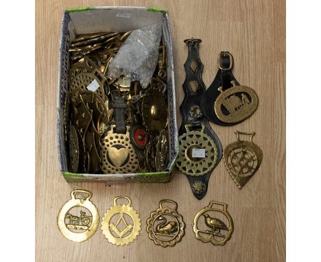 A large collection of horse brasses mainly early 20th Century patterns to include: geometric motifs, crescents, animals (hogs