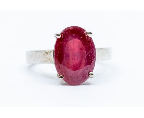 A ruby and silver dress ring, comprising an oval cut blue topaz approx 13 x 9mm, weight approx 6 carats, size P, total gross 