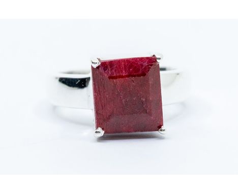 A ruby and silver dress ring, comprising a claw set rectangular cut ruby approx 10 x 11mm, weight approx 6 carats, size R, to