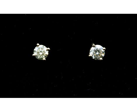 A pair of diamond and 18ct white gold solitaire earrings, comprising claw set round brilliant cut diamonds, weighing a total 