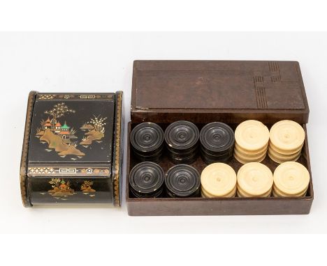 A vintage ebonised and ivorine turned draughts set together with a Japanese lacquered box, decorated with pagodas (2)&nbsp;&n