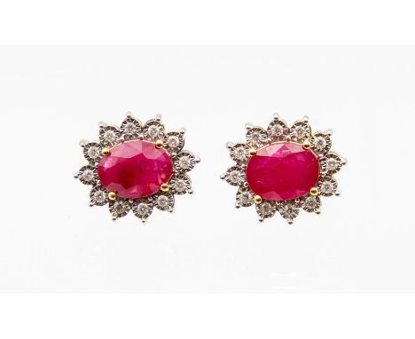 A pair of ruby and diamond 9ct gold cluster earrings, comprising claw set oval rubies, total stone weight approx 3.85 carats,