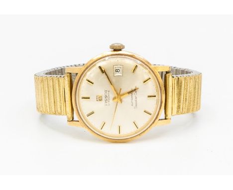 A 1960s 9ct gold Tissot Seastar seven automatic wrist watch, round champagne dial with applied gold tone baton markers, date 