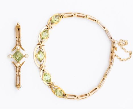 A peridot and unmarked yellow metal bracelet, comprising five lozenge shaped peridot rubover set to the centres of open oval 