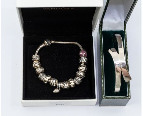 A silver Pandora bracelet complete with fourteen charms including hearts, stone set and enamel versions, 19.5cm, in original 