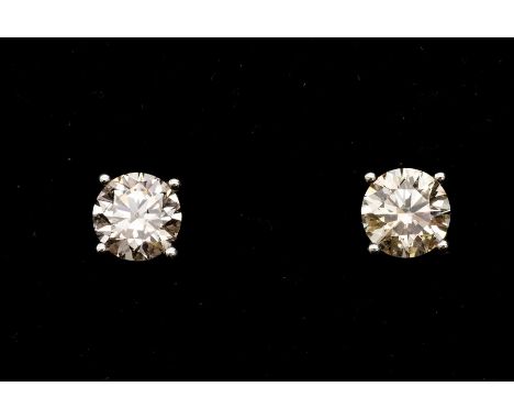 A pair of diamond and 18ct white gold solitaire earrings, comprising claw set round brilliant cut diamonds, weighing a total 