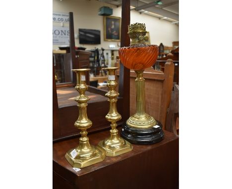 A Victorian style brass oil lamp with amber glass reservoir, on ebonised plinth together with a pair of Victorian style brass