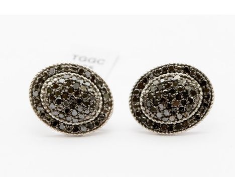 A pair of black diamond and silver oval earrings, oval form with domed centre&nbsp;pave set with small round cut black diamon